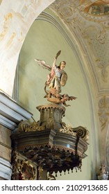 Gheorgheni Romania 28. May 2021. Pulpit, Statue Of St. Michael At The Top, The Satan Under His Feet  In The Armenian Catholic Church Of Gyergyószentmiklós