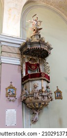 Gheorgheni Romania 28. May 2021. Pulpit, Statue Of St. Michael At The Top, The Satan Under His Feet  In The Armenian Catholic Church Of Gheorgheni Gyergyoszentmiklos