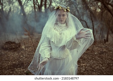 Ghost Of Bride. A Beautiful Bride Lady In A White Dress And Covered With A Veil, Wandering Alone Through The Old Park. Victorian Style. Mystical Love Novel.