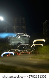 The Ghost Convoy, the static skyscraper patterns to the dynamic movement of individual vehicles, capturing the momentary, luminous shape of traffic against the night.