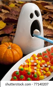 Ghost With Halloween Candy Getting His Teeth Brushed