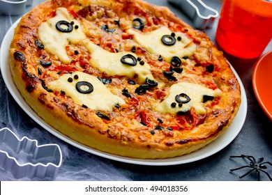 Ghost Halloween pizza, funny pizza decorated with cheese and olives ghosts