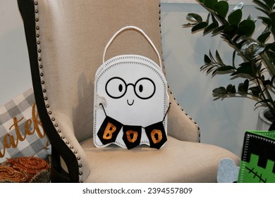 A ghost shaped trick or treat bag that says "BOO". - Shutterstock ID 2394557809