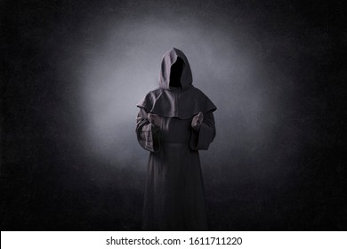 Ghostly figure with open hands in the dark