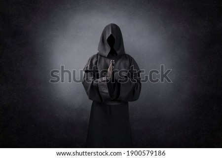Ghostly figure praying in the dark