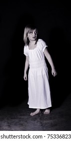 A ghostly looking girl wearing a white night gown