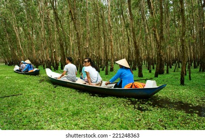 AN GIANG, VIET NAM- SEPT 22: Tra Su Indigo Forest, Eco Tourist Area At Mekong Delta, Traveler In Green Ecotourism, Woman Rowing The Row Boat, Hyacinth Cover Water, Tree Flooded, Vietnam, Sept 22, 2014