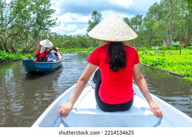 An Giang, Vietnam - September 3rd, 2022: Traveler Beautiful Woman On A Boat Tour Along The Canals In The Mangrove Forest. This Is An Eco Tourism Area At Mekong Delta In An Giang, Vietnam