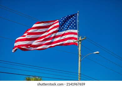 Giant American Flag With Blue Sky On The Background