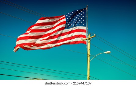 Giant American Flag With Blue Sky On The Background