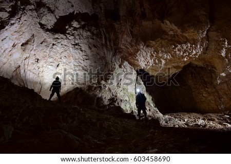 A giant cave with two men