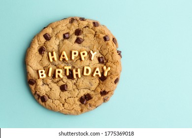 Giant Chocolate Chip Cookie With Happy Birthday Written In Gold Letters