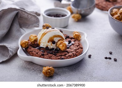Giant chocolate skillet cookies with popcorn, salted caramel syrup and ice cream