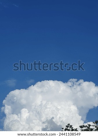 a giant cloud in the blue sky