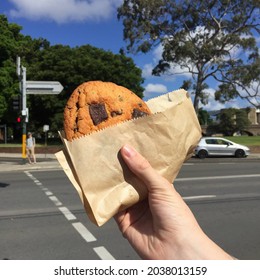 A Giant Cookie Holding With One Hand