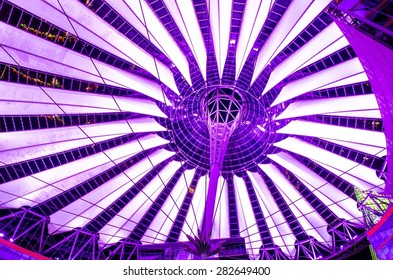 giant copula of sony center in berlin is made of white strips and is illuminated during night