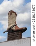 Giant Cowboy Boot on Sign of Abandoned Business Located in Rural Texas. Weir TX