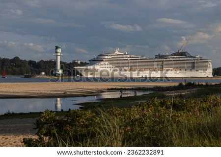 Giant cruise ship passing the Friedrichsort lighthouse at the Falckenstein beach.