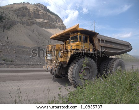 Giant dump truck makes it way into the Canadian Rocky Mountains near an open pit coal mine Stock photo © 