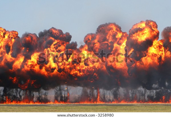 Giant Explosion! A wall of fire explodes on an\
open field.