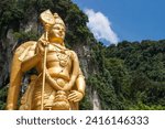 Giant golden statue of Hindu god Lord Murugan outside entrance to Batu Caves, Kuala Lumpur, Malaysia