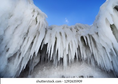 Giant Ice Blocks And Blue Frosty Sky. Icicles.
