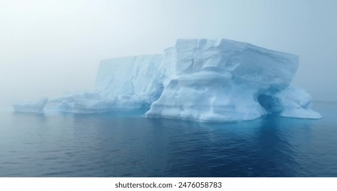 Giant iceberg drifts Antarctica ocean morning fog. Mystery dramatic mist scene. Glacier melting, climate change impact on polar environment. Antarctic travel and exploration. Drone shot close up - Powered by Shutterstock