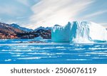 A giant iceberg is slowly floating on the sea - Picturesque village on coast of Greenland - Colorful houses in Tasiilaq, East Greenland