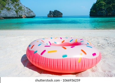 Giant Inflatable Pink Donut Pool Float Toy On The Tropical Beach, Sea