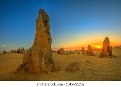 Giant limestone formation at dusk. The Pinnacles Desert in Nambung National Park, offers, at sunset, the show with the best colors. The Pinnacles is a major tourist attraction in Western Australia. - Shutterstock ID 1017651232