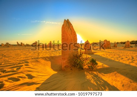 Giant limestone formation illuminated by red sunset light. Pinnacles Desert in Nambung National Park, Western Australia.During late afternoon and sunset the Pinnacles are illuminated by the best light