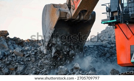 Giant mining excavator in the process of extracting rock material in an open pit mine