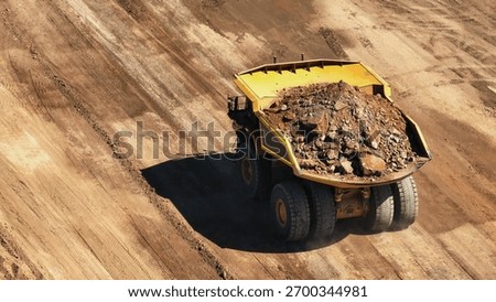 Giant mining truck in the process of transporting minerals from the mine