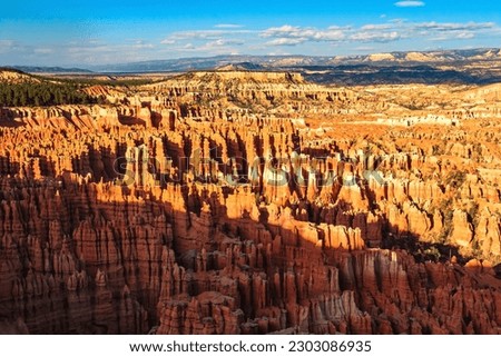 Giant natural amphitheater created by erosion. Hoodoos are unique geological structures formed by erosion. Incredible landscape illuminated by the sunset. Bryce Canyon in the USA. 