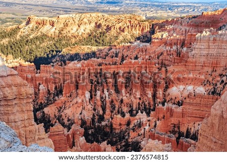Giant natural amphitheater created by erosion. Hoodoos are unique geological structures formed by erosion. Incredible landscape illuminated by the sunset. Bryce Canyon in the USA. 