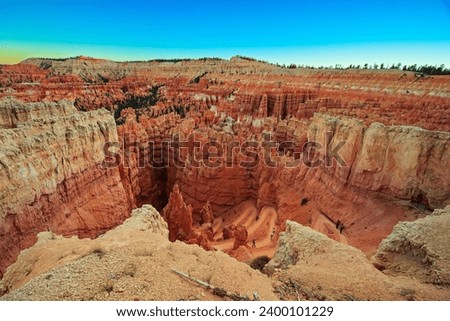 Giant natural amphitheater created by erosion. Bryce Canyon in the USA. Hoodoos are unique geological structures formed by erosion. Incredible landscape illuminated by the sunset.