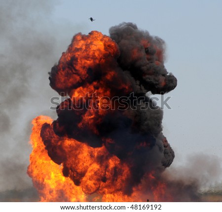 Giant outdoor explosion with fire and black smoke