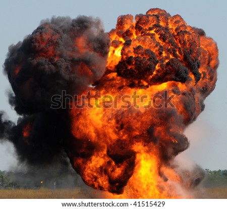 Giant outdoors explosion with fire and black smoke