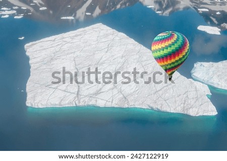 A giant piece of iceberg has broken away from the Glacier - Hot air balloon flying over A giant piece of iceberg - Greenland