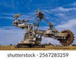 Giant rotary bucket excavator, industrial landscape. Extracting fossil fuels