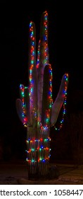 A Giant Saguaro Cactus Is Decorated In Christmas Lights For The Holiday Season.