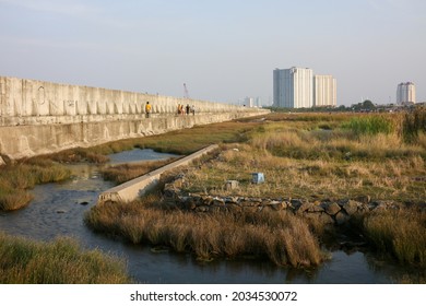 Giant Sea Wall, Jakarta, Indonesia - August 28 2021: A Four Meters Wall Built To Prevent Sea Water Comes In The Inner Land Due To Sea Level Rise. The Fastest Sinking City. (Masjid Tenggelam)