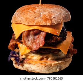 Giant size triple cheese, extra bacon & triple grill pork or beef burger in black background