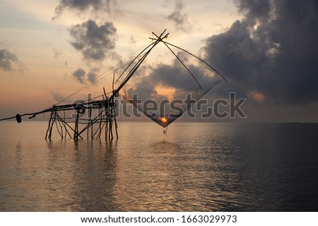 Giant square dipnets for trapping fish and sunrise in the net