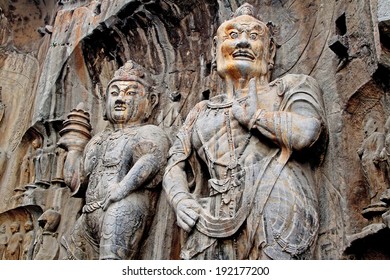 Giant stone representation of a Bodhisattva and Guardian of The Buddha in Longmen cave, China. Canon 5D.