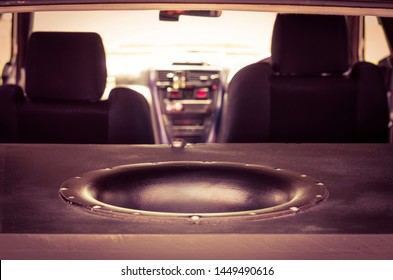 Giant Subwoofer Sound Speaker In The Trunk. Blurred Car Interior.