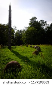 
A Giant Sundial On A Meadow Near The Forests