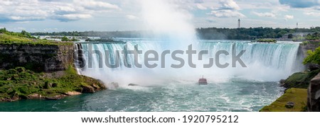 Giant Water Falls with Mist coming of Cruise Ship tourist Ship Niagara Falls on the US Canadian Border in North America