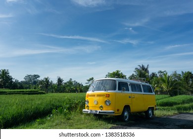 Gianyar, Bali / Indonesia - 1 April 2017: A Yellow VW (Volkswagen) Van / Bus parked on the side of the road, surrounded by rice field in Bali.