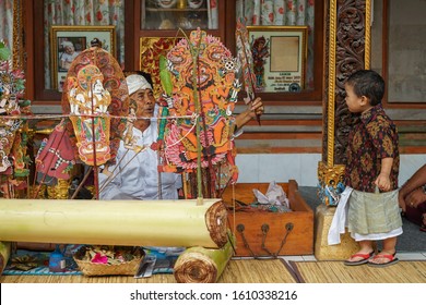 GIANYAR/BALI-AUGUST 14 2019: A Young Balinese Child Watching A Shadow Play. Wayang Kulit Or Shadow Puppets Is One Of Balinese Arts That Is Continuously Preserved